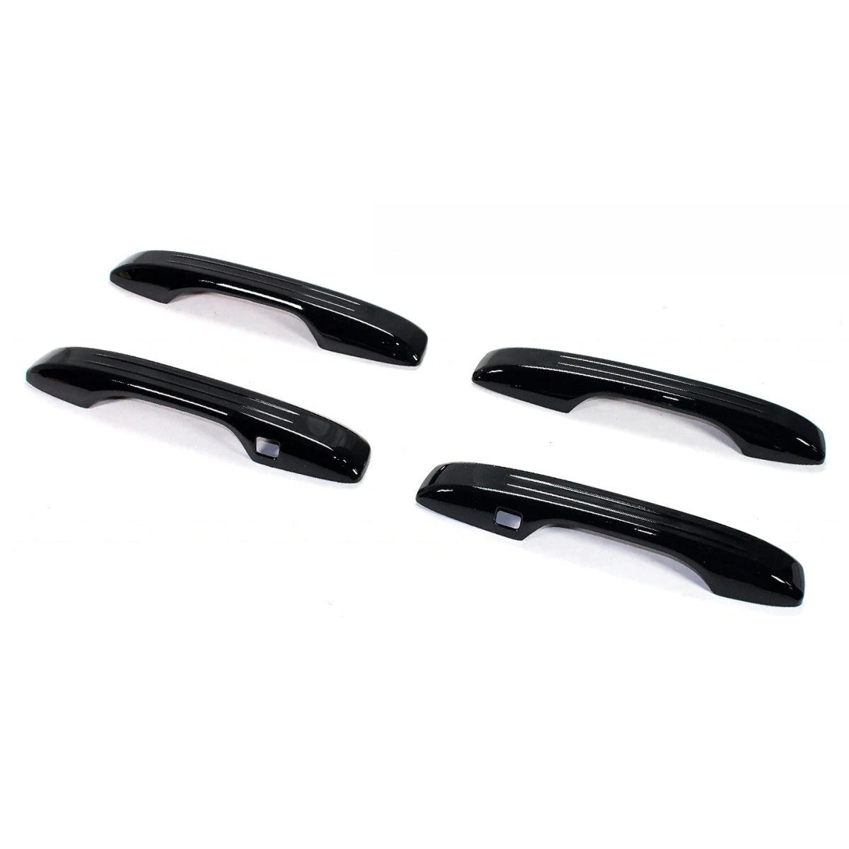 Three-quarter view of four gloss black Acura Integra door handle covers with cutouts