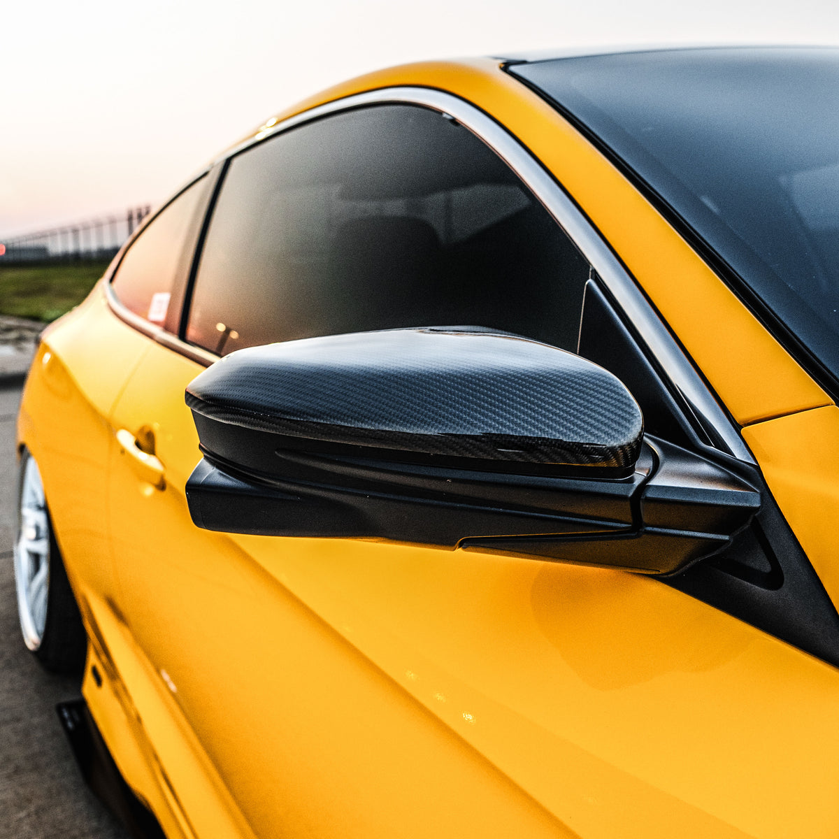 Carbon fiber mirror replacement caps with gloss finish installed on a Honda Civic (1)