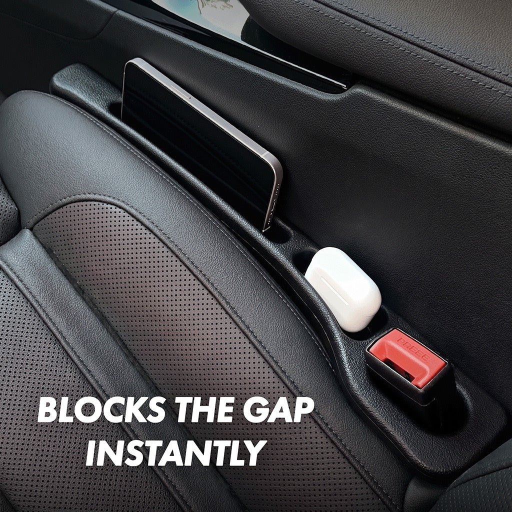 Close-up interior view of black car seat gap filler beside a Civic seat, with phone holder and AirPods slot