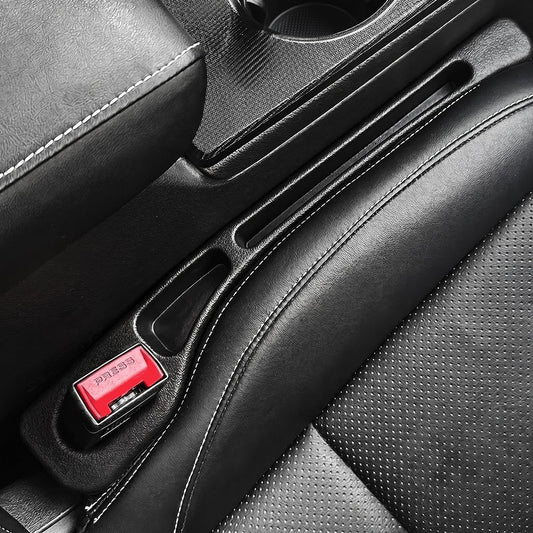 Close-up interior detail of black leather Honda Civic seat gap filler with red PRESS latch