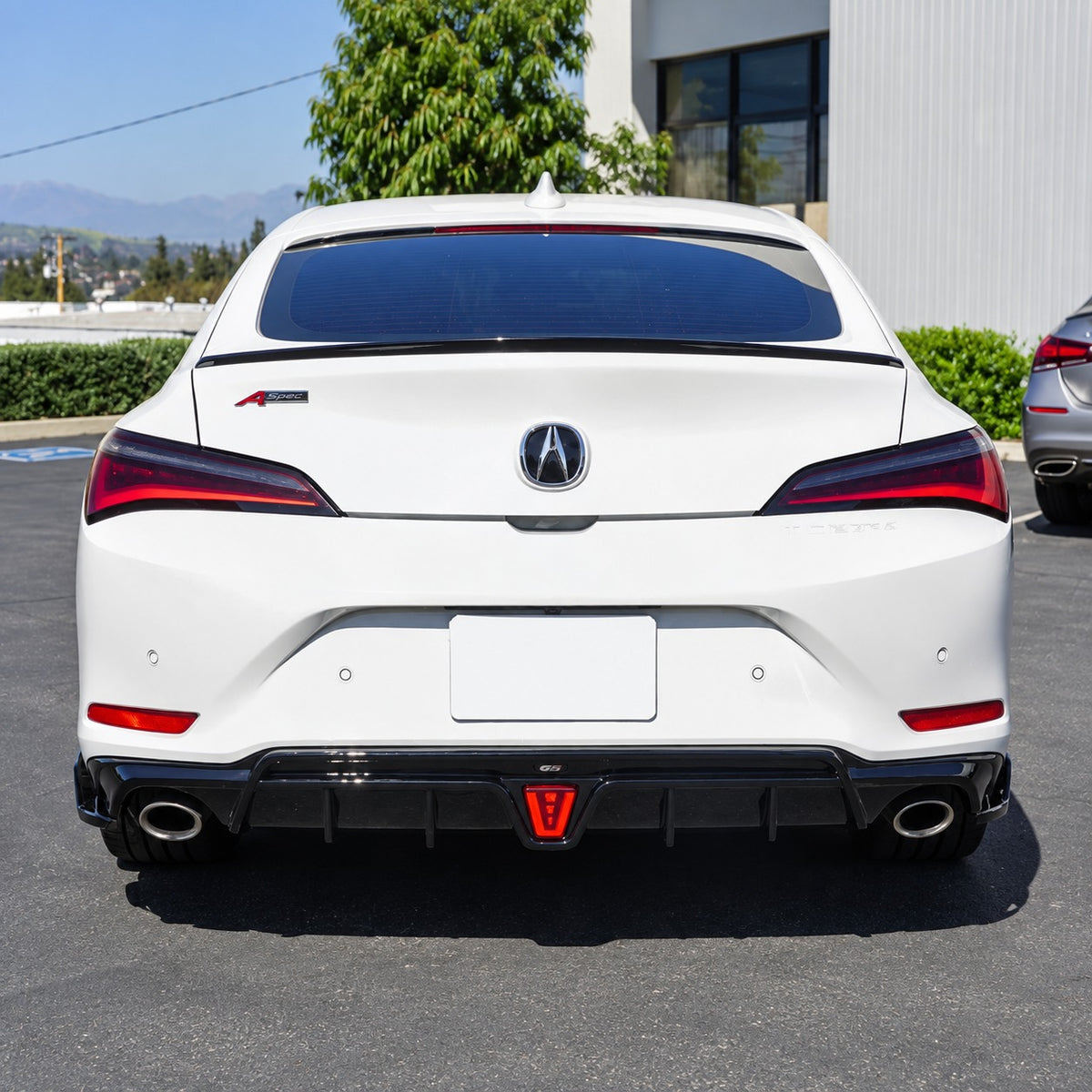 Gloss black LED rear diffuser with shark fin extensions installed on Acura Integra rear bumper (1)