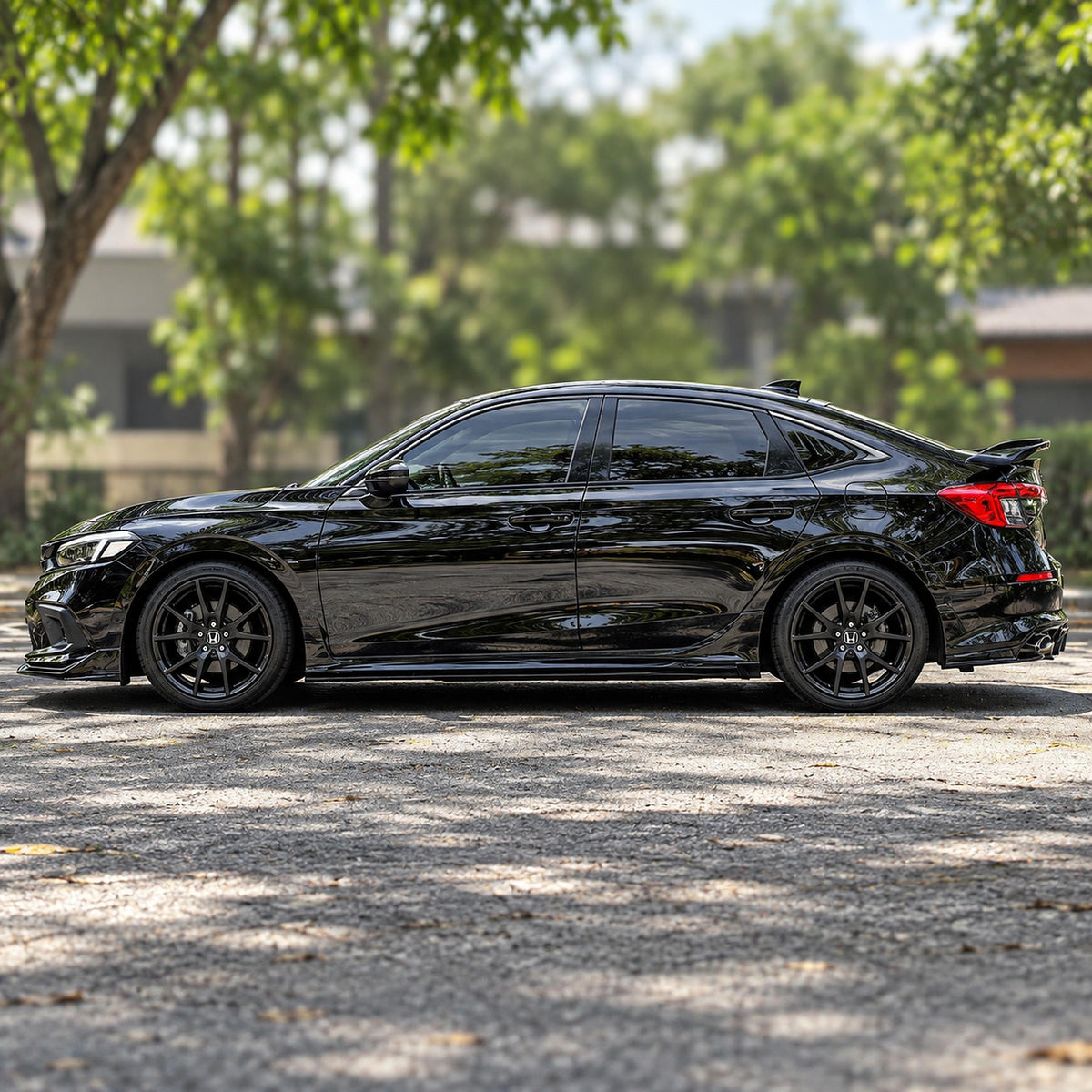Pair of gloss black side skirt extensions installed on Honda Civic sedan (2)