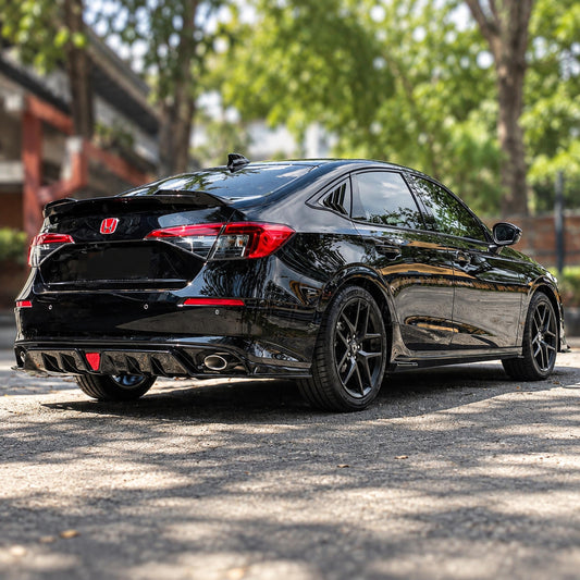 Pair of gloss black side skirt extensions installed on Honda Civic sedan (1)