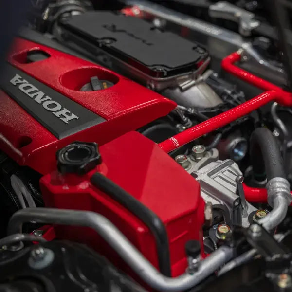 Red silicone radiator hoses with reinforced construction and worm gear clamps installed in engine bay (2)