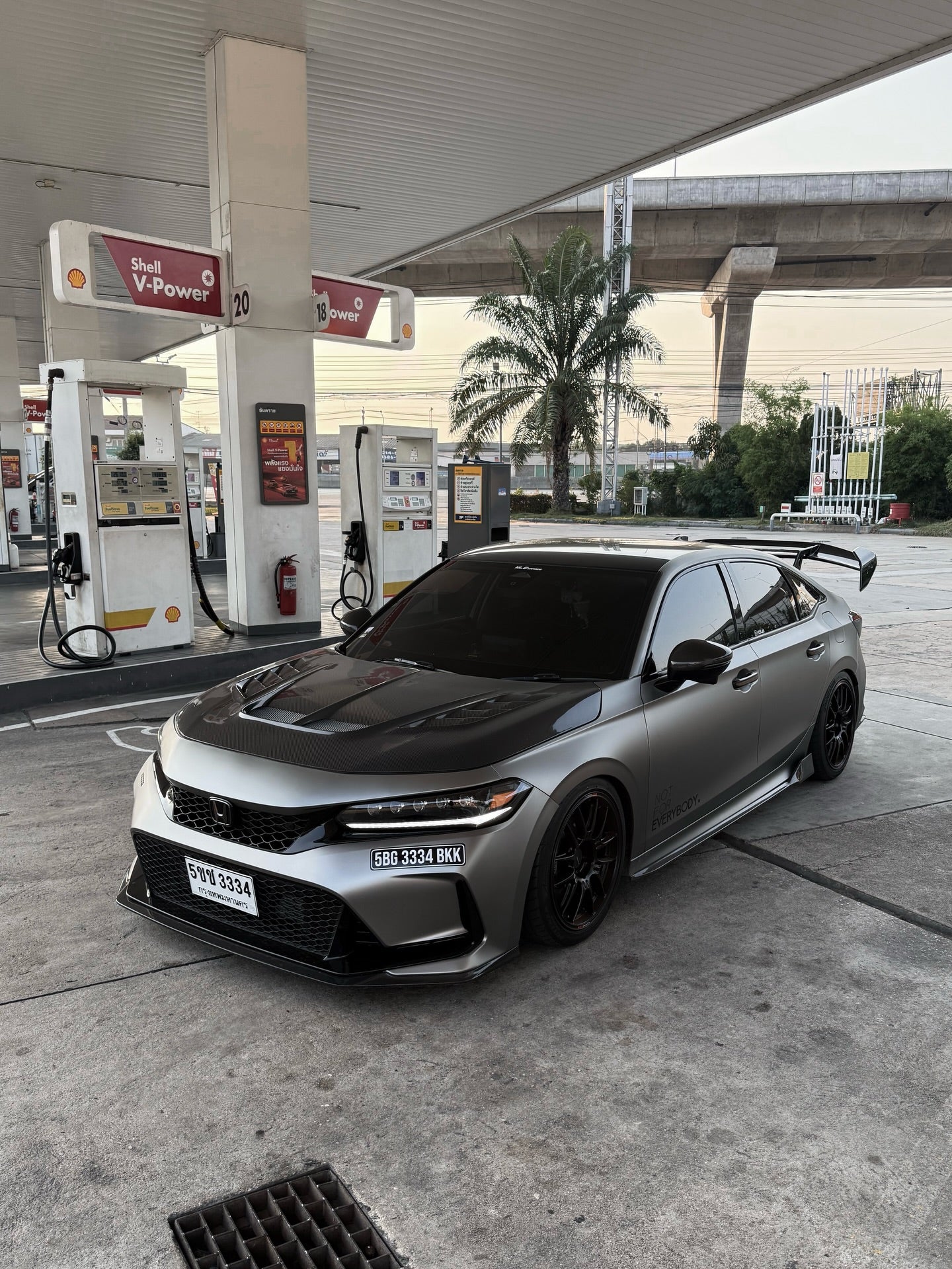 Matte black carbon fiber hood with dual vents on 2023+ Honda Civic Type R FL5, lifestyle installed view
