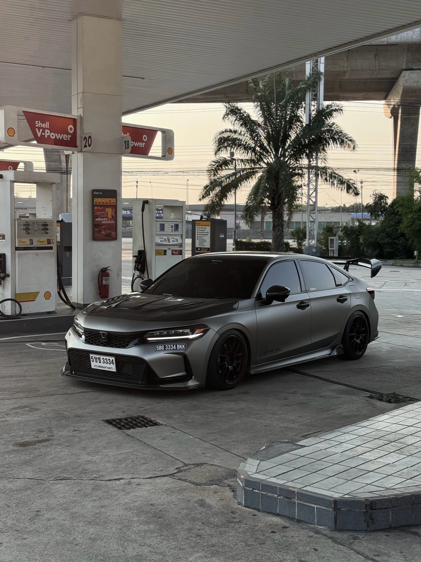 Gray Honda Civic Type R FL5 with Ums Carbon Fiber Hood V2, three-quarter angle at gas station