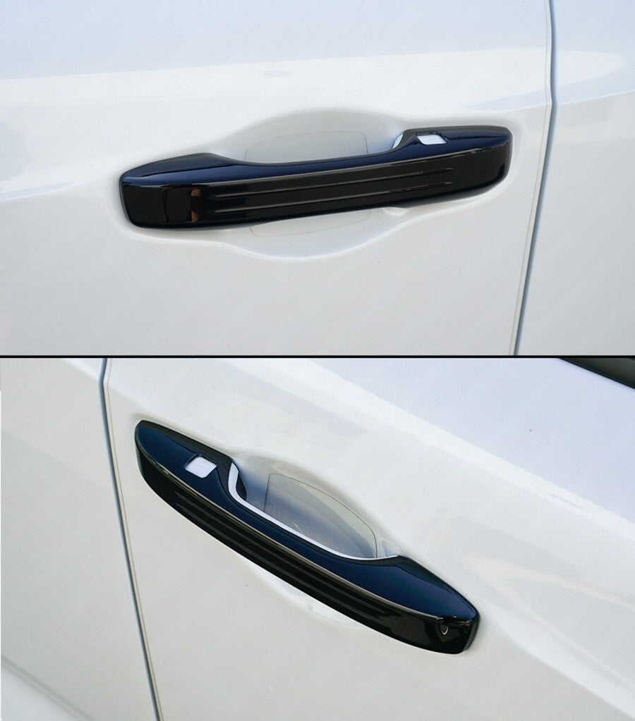 Close-up three-quarter view of gloss black Acura Integra door handle covers on white door panels